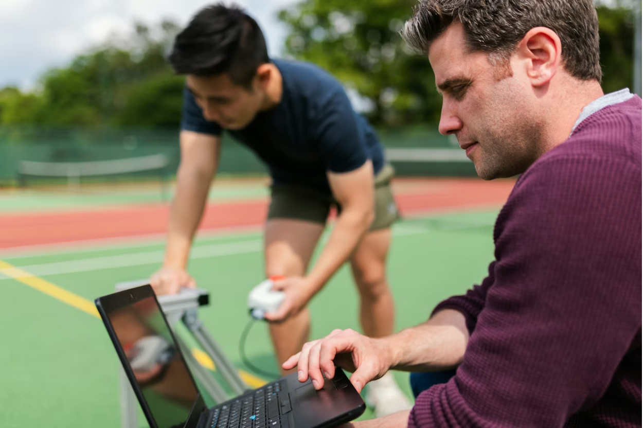 Fitness coach reviewing statistics and reports of player